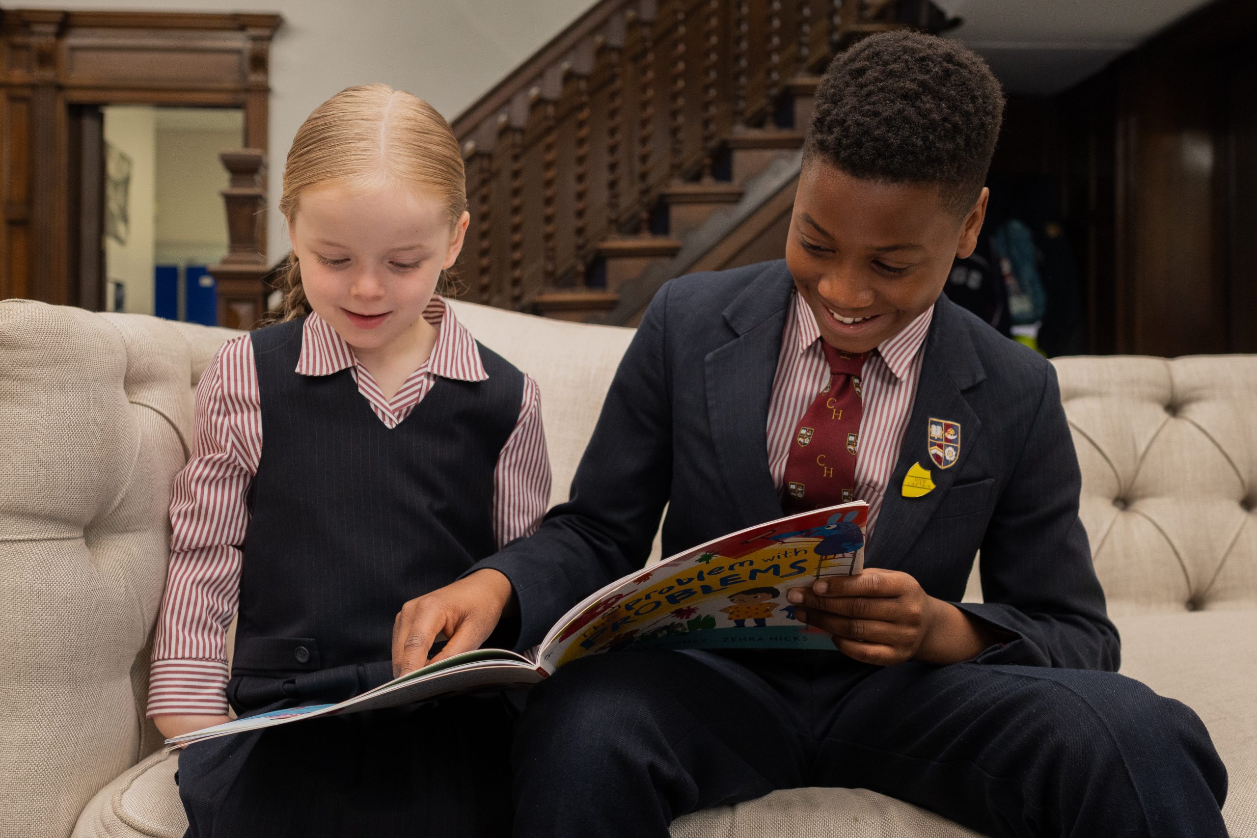 Two children reading a book together