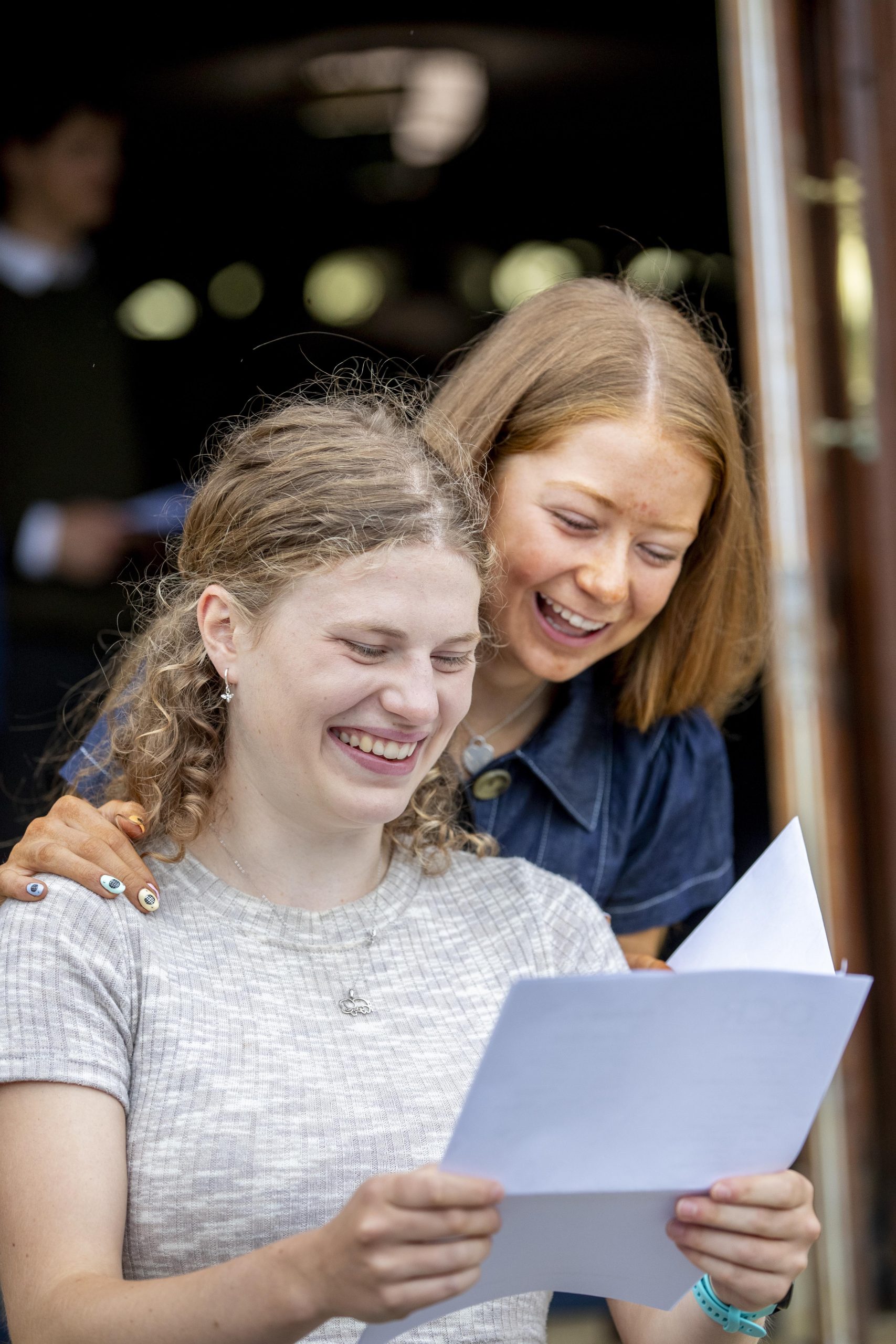 Two students looking at their results papers