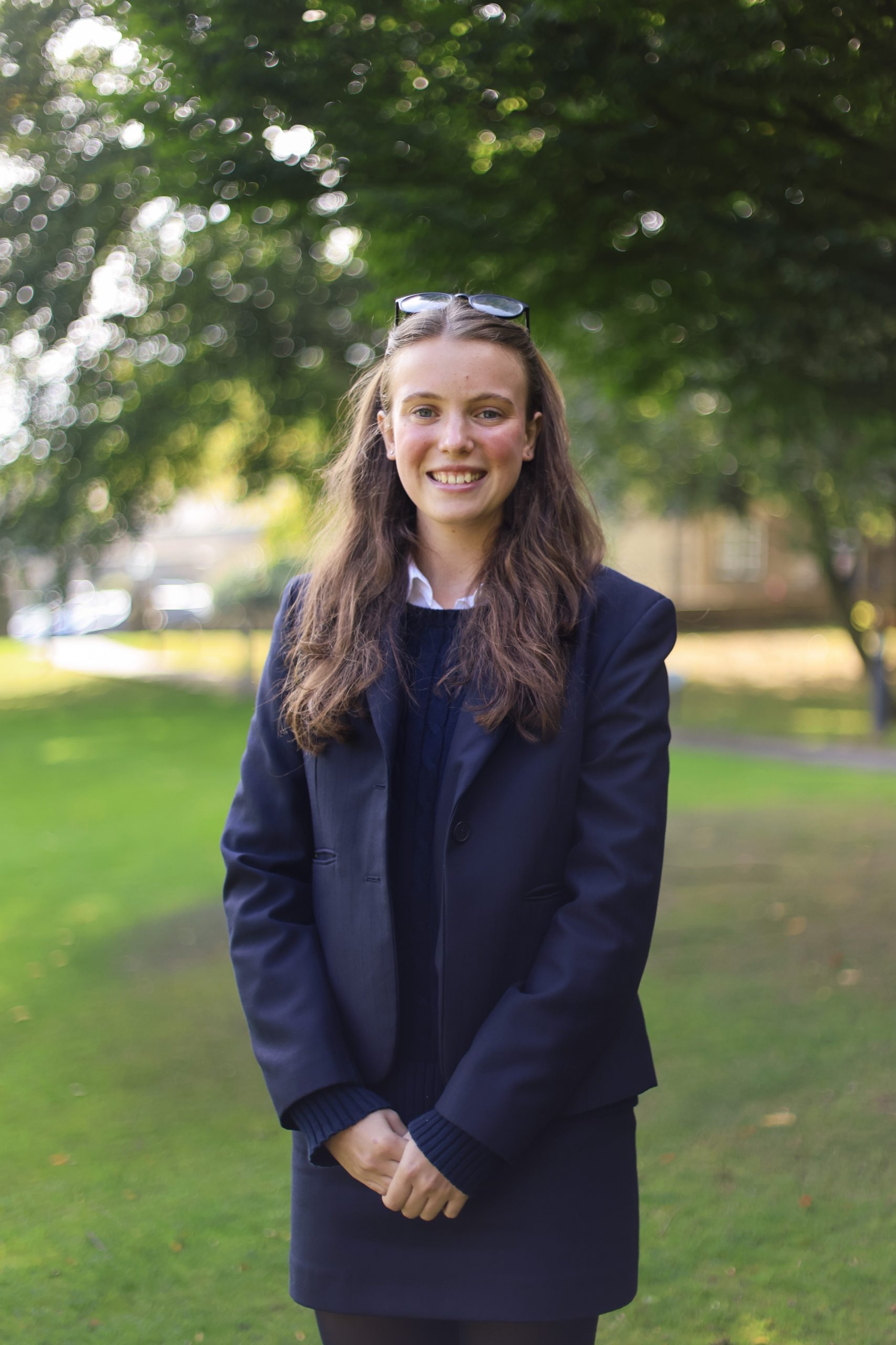 Megan stood smiling on school grounds