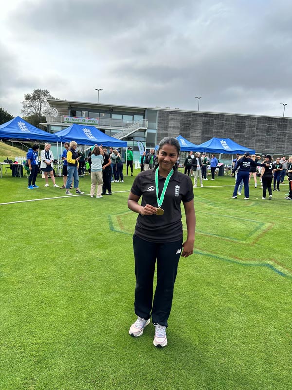 Year 10 pupil, Venus, wearing a cricket medal