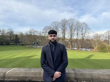 Bradford Grammar Year 13 pupil stood in front of a wall.